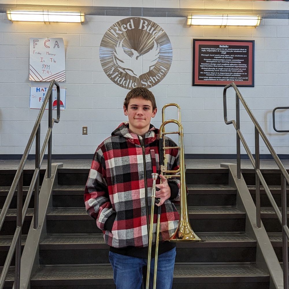 BRYSON SITTEN STANDS WITH HIS TROMBONE