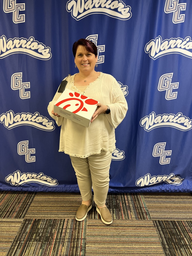 Woman stands holding a Chick-Fil-A boxed lunch 