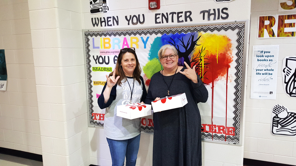 2 staff members showing their lunch