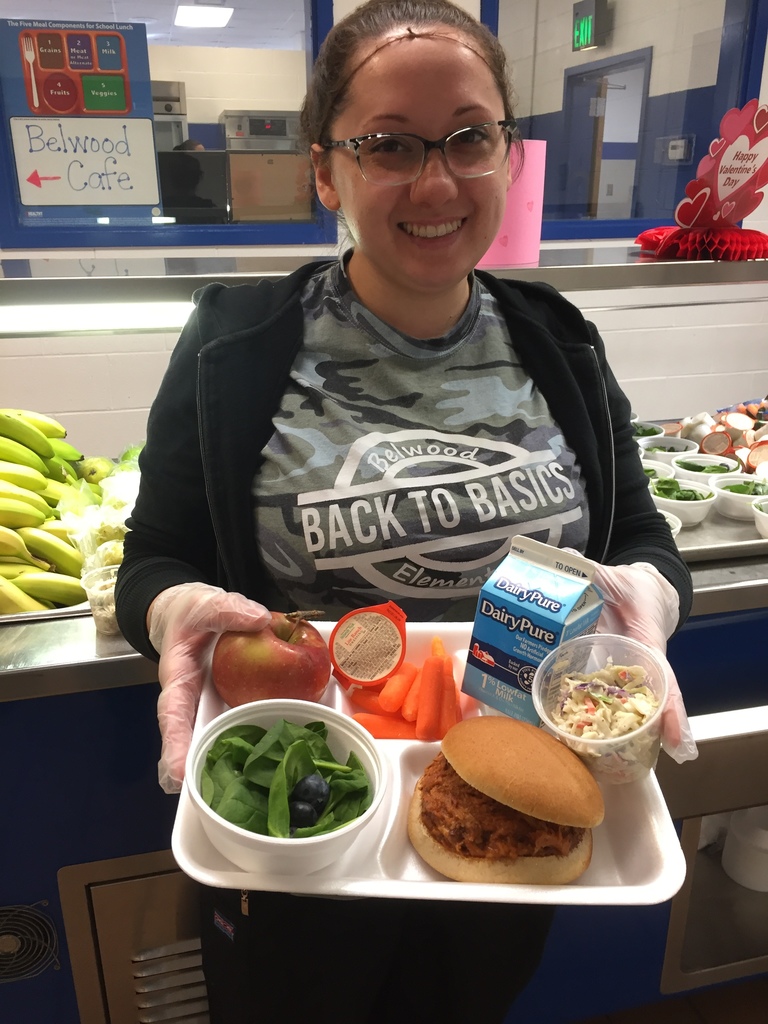 Cafeteria worker holding a school lunch tray