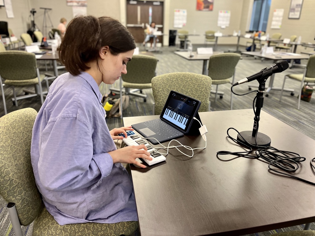 1 student plays a digital keyboard