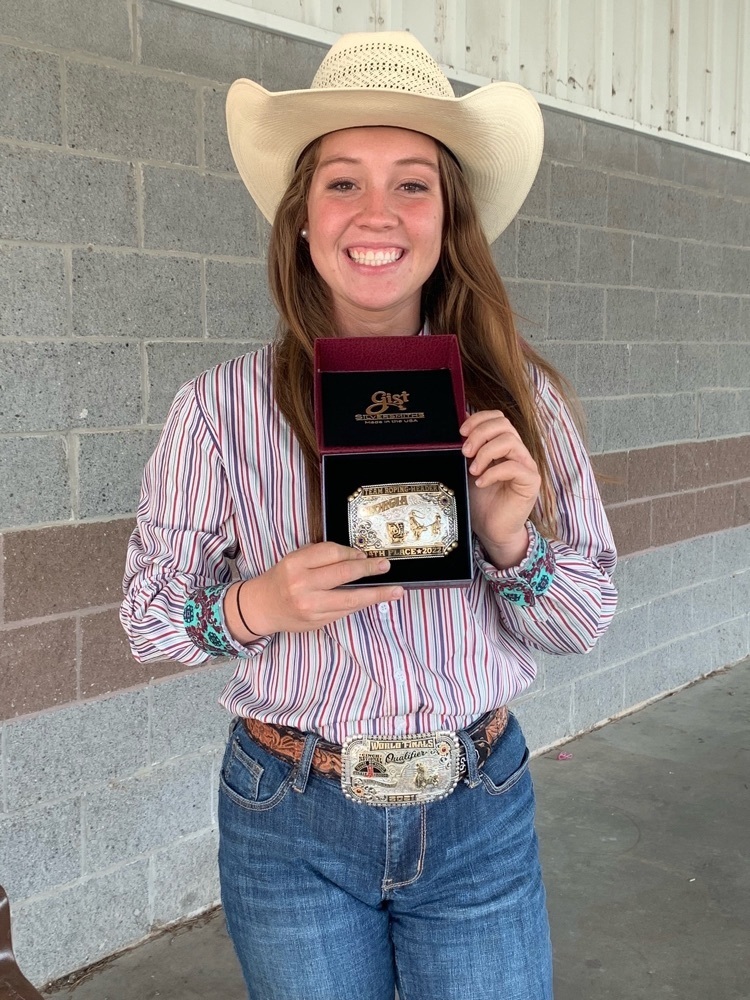 girl holds a gold buckle