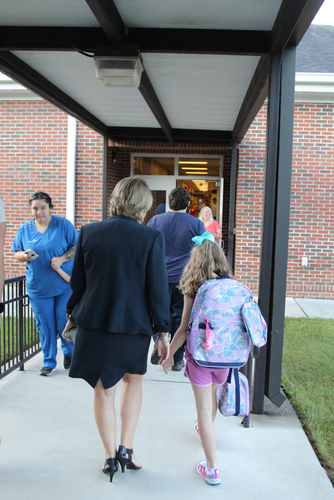 Dr. Fraker walks with a student to class