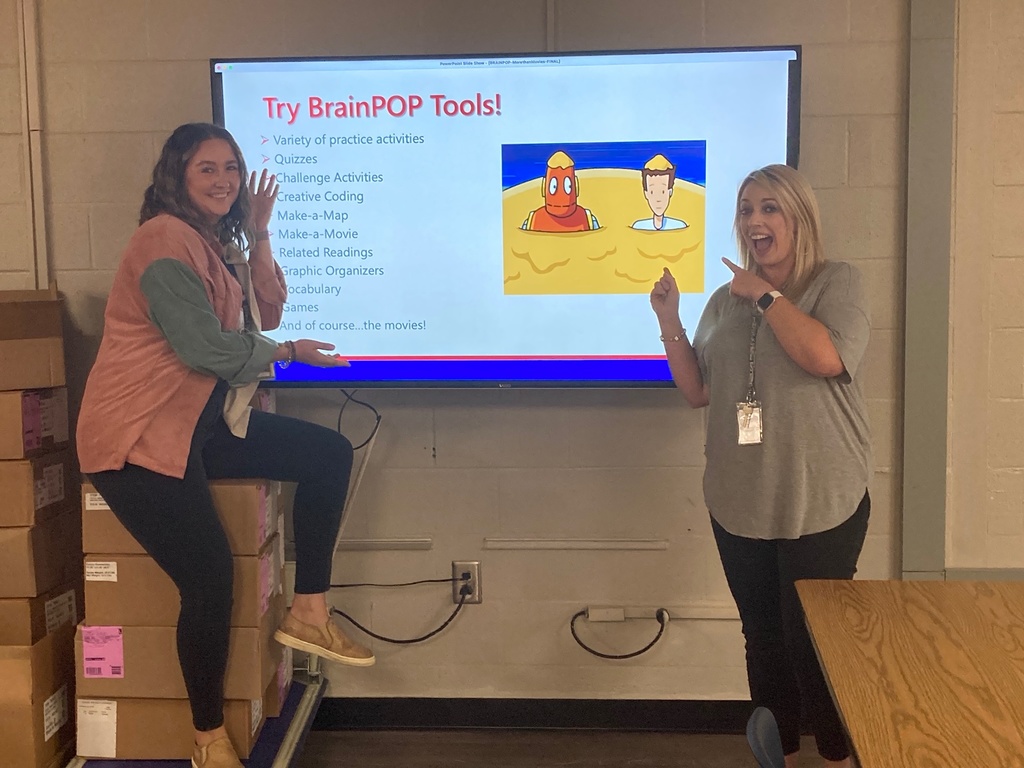 Non-Informative: Two teachers stand in front of a slide
