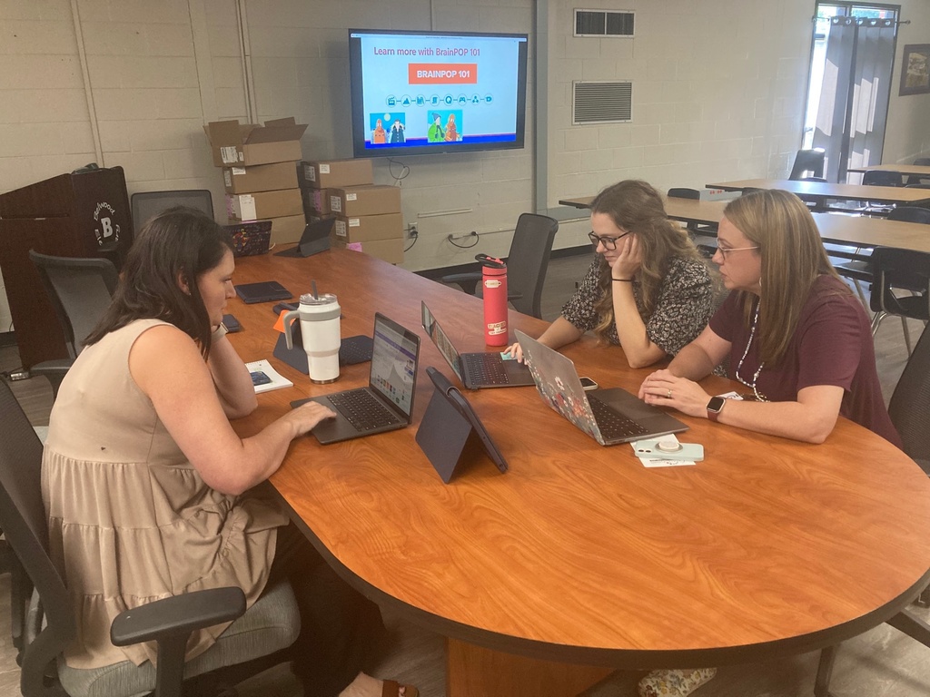 Non-Informative: A group of teachers work on computers