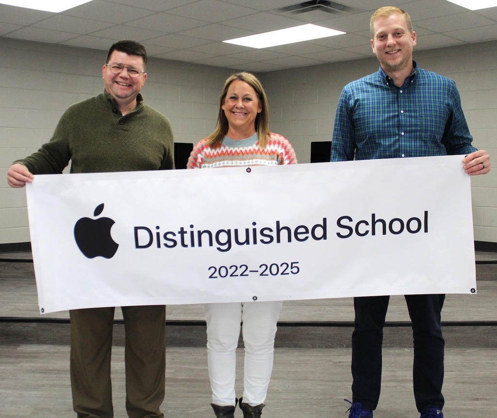 A group takes a picture with the ADS banner
