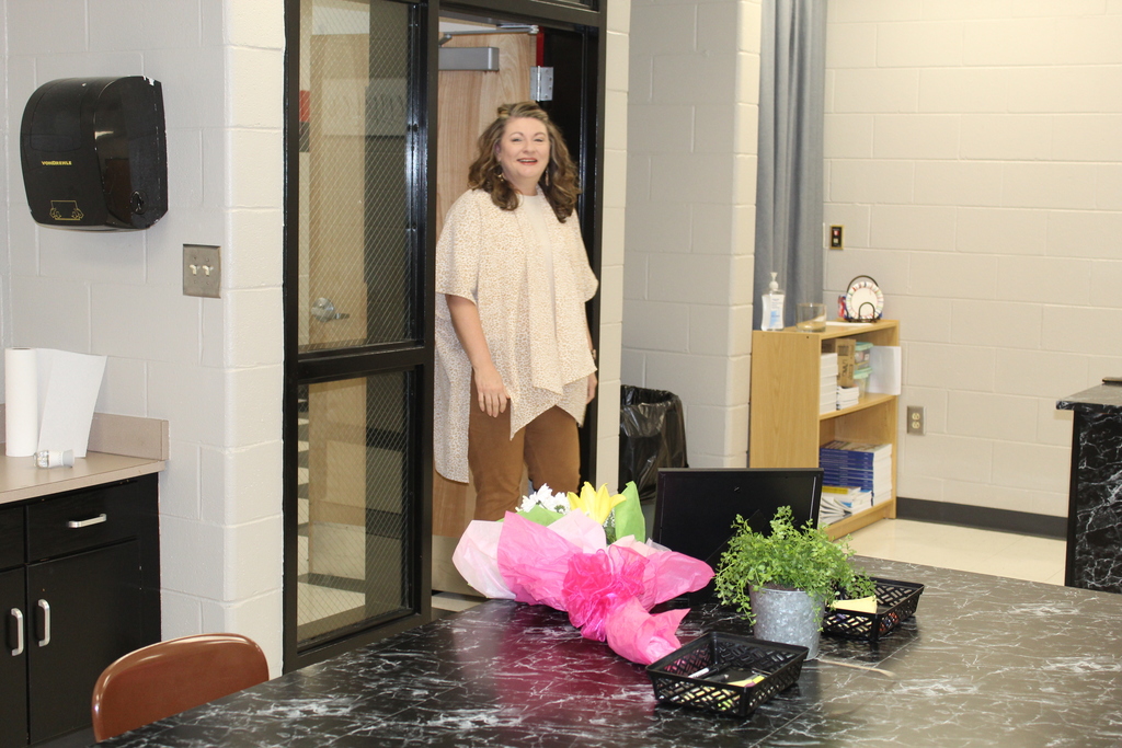 LADY AT DOOR WITH FLOWERS
