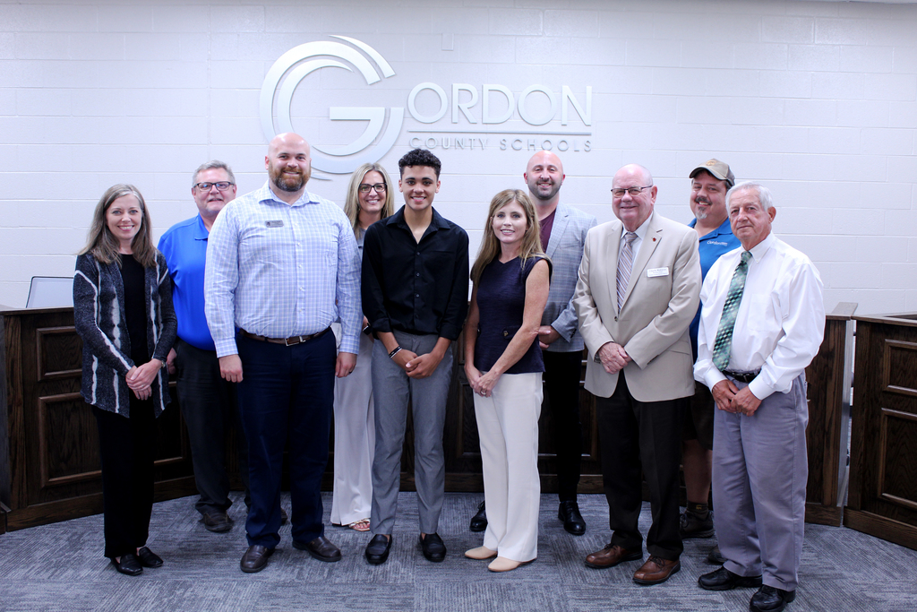 the gordon county schools board of edcuation stands together with ashton henson and brian hall for a group photo