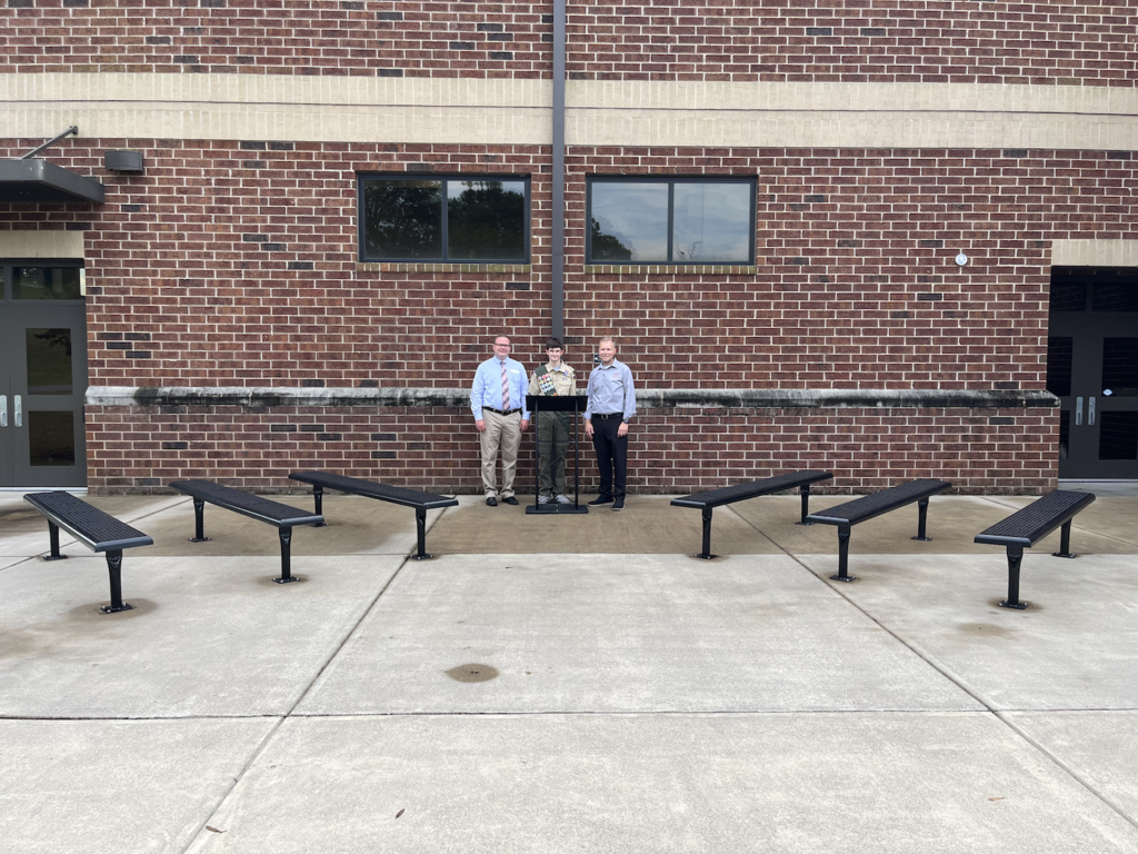 Kaleb King, Chad Moore and Justin Timms stand in the outdoor classroom