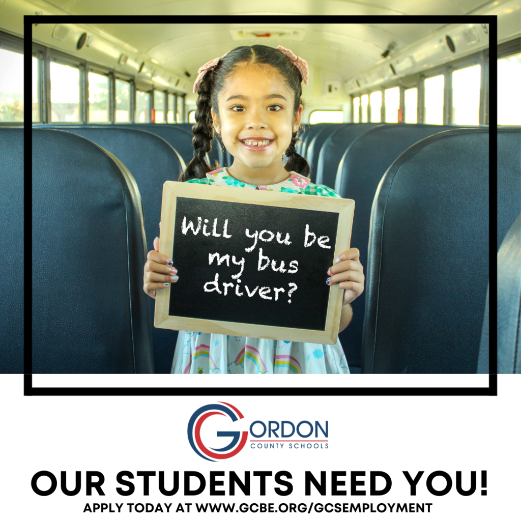 a little girl smiles while holding a sign that says "will you be my bus driver?" the wording below states "our students need you! apply today at www.gcbe.org/gcsemployment"