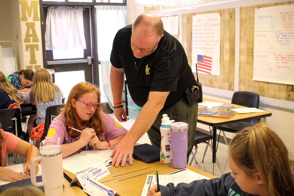 an officer helps a student with her work